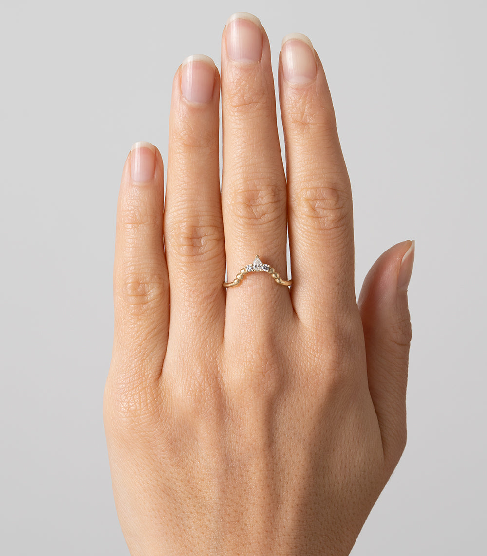 Tiara Nesting Band AL-R14 14K yellow gold shiny ring with small center diamond and scalloped design on hand