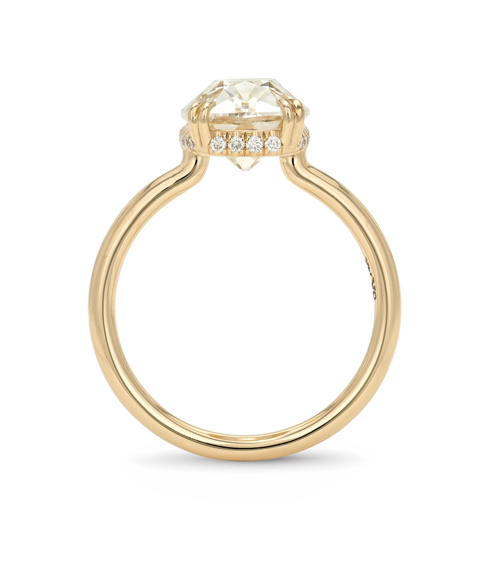 Gold ring with a diamond on a white background