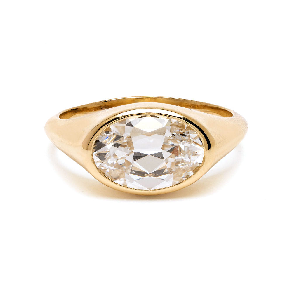 Gold ring with a large diamond on a white background