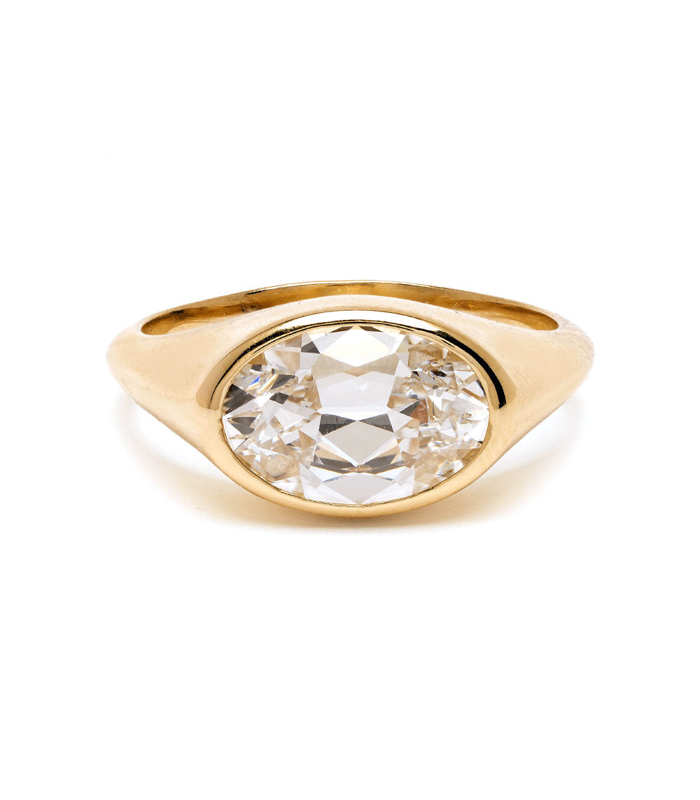 Gold ring with a large diamond on a white background