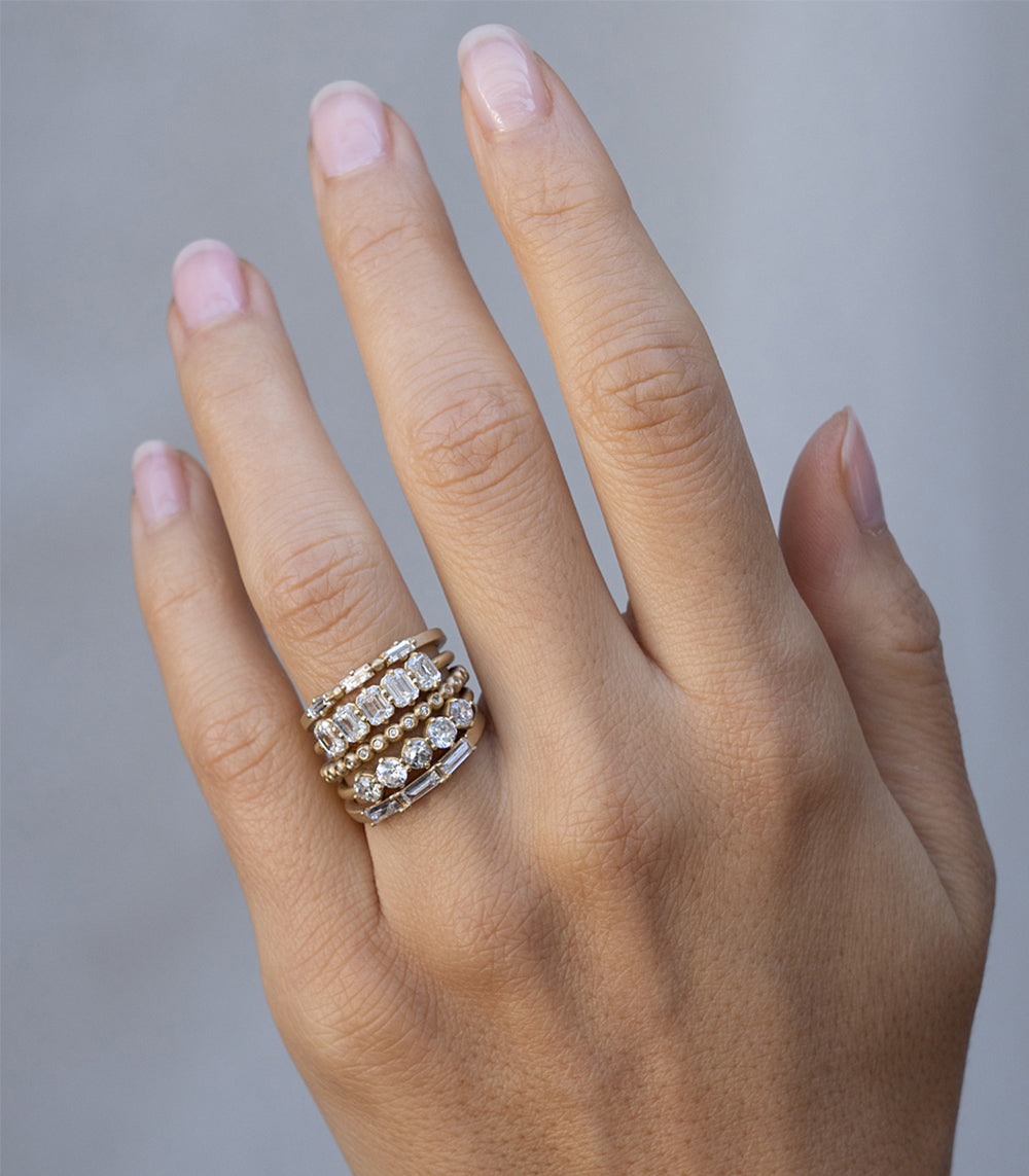 Claudette 5 Stone Band SK-R68-Band-EC gold band with five sparkling stones shown on hand
