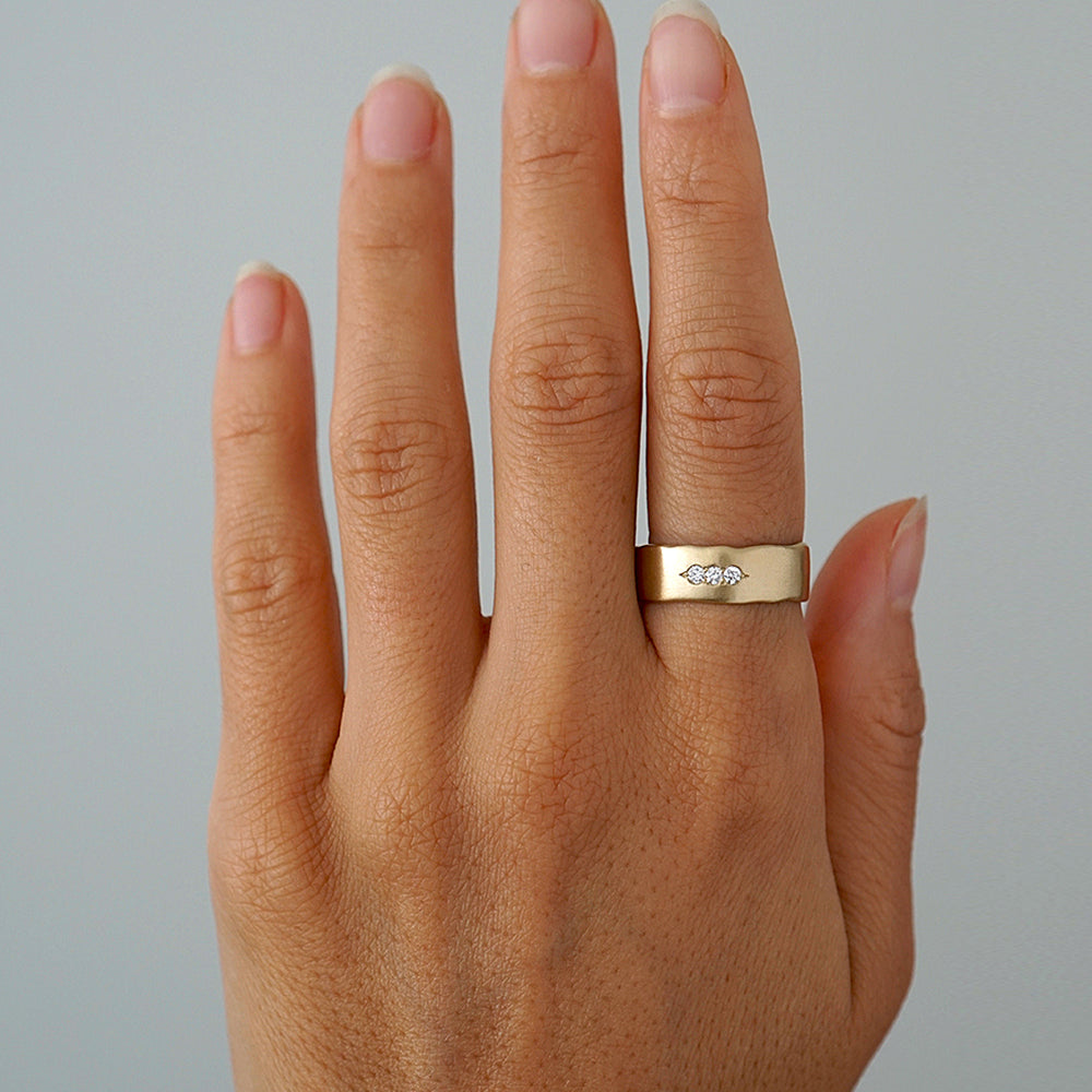 Ducks in a Row P-R3-Horz ring in gold with a small diamond, shiny finish on a hand