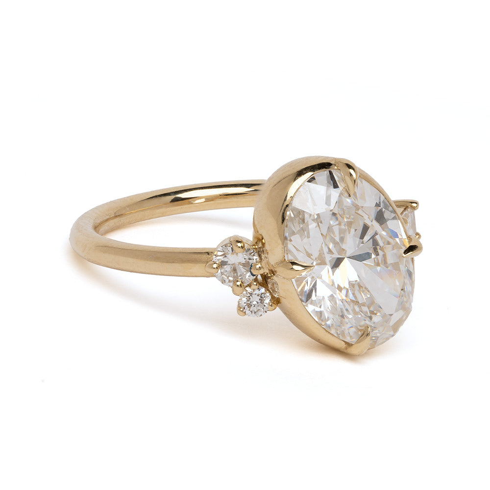 Sydney SK-R96-LGD-OC-3.01 gold engagement ring with large oval diamond and two small stones.