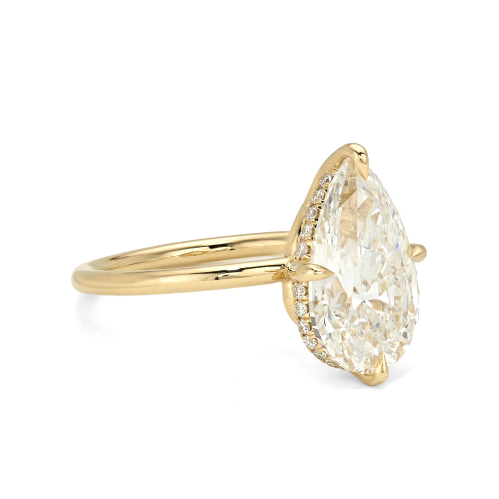 Annika Sofia Kaman diamond ring in gold with oval-cut diamond center and slim band