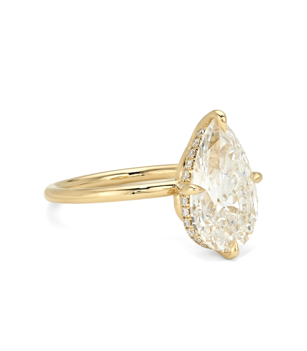 Annika Sofia Kaman diamond ring in gold with oval-cut diamond center and slim band