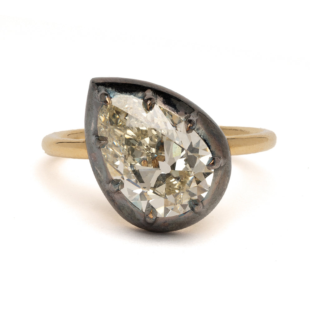 Cora KM-R3 engagement ring with oval-cut diamond in dark bezel setting on gold band