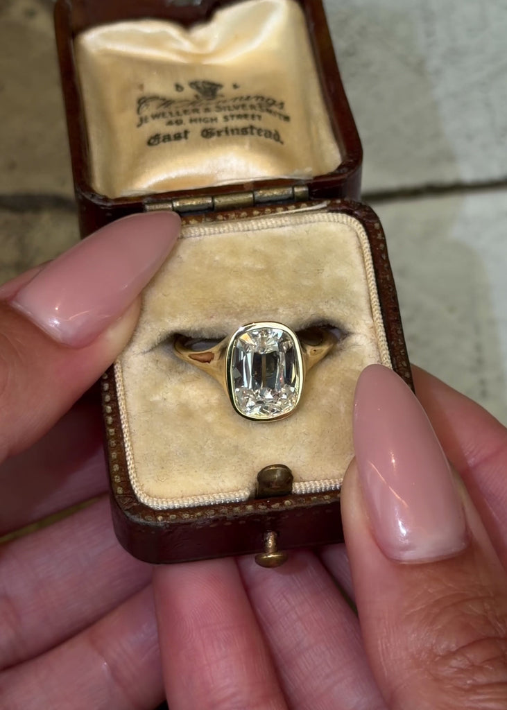 old mine cut style lab diamond cushion cut in a bezel-set signet style engagement ring in 1 shiny yellow gold