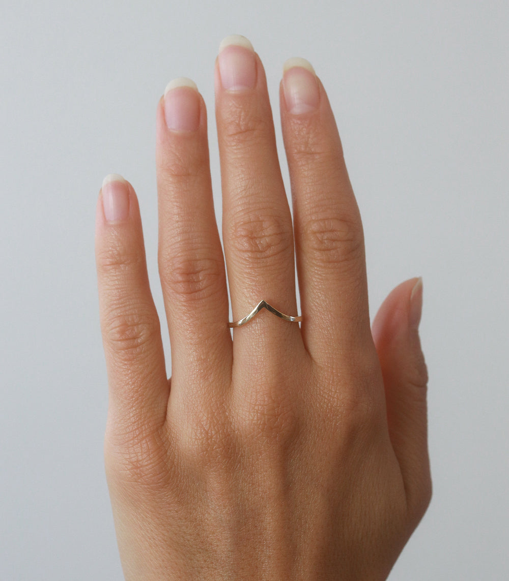 Chevron Band A-R39 14K yellow gold matte finish chevron band ring worn on finger close-up