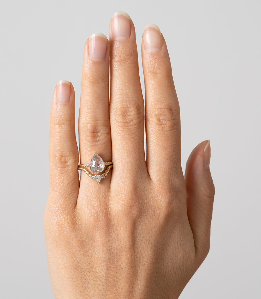 Tiara Nesting Band AL-R14 14K rose gold shiny nesting band with pear-shaped center stone on finger