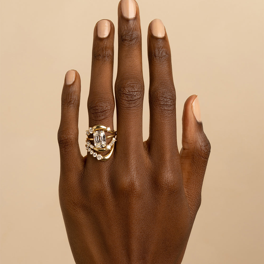 Medium Melt Band EGB-R15 ring in 14K yellow gold with shiny prong-set stones on finger