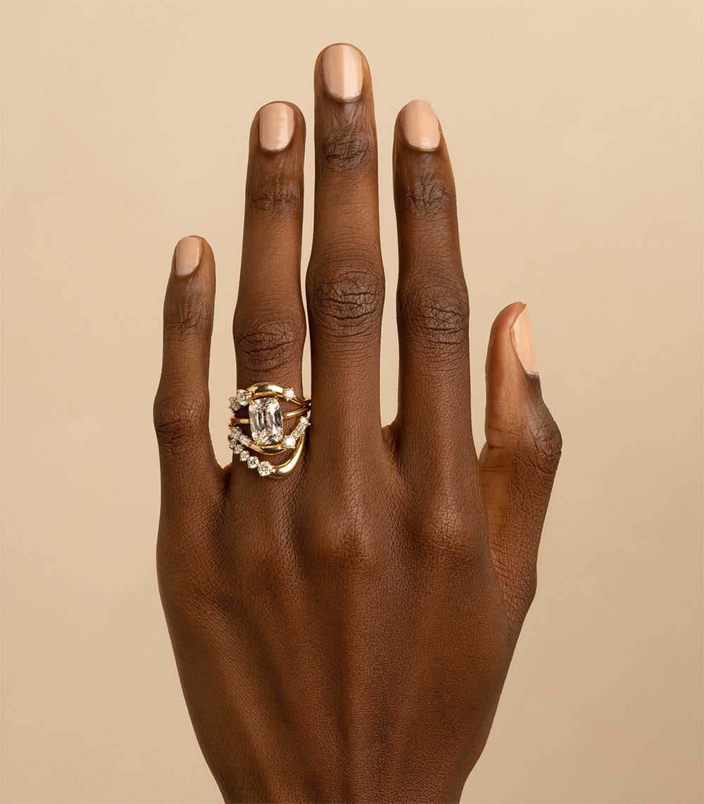 Medium Melt Band EGB-R15 ring in 14K yellow gold with shiny prong-set stones on finger