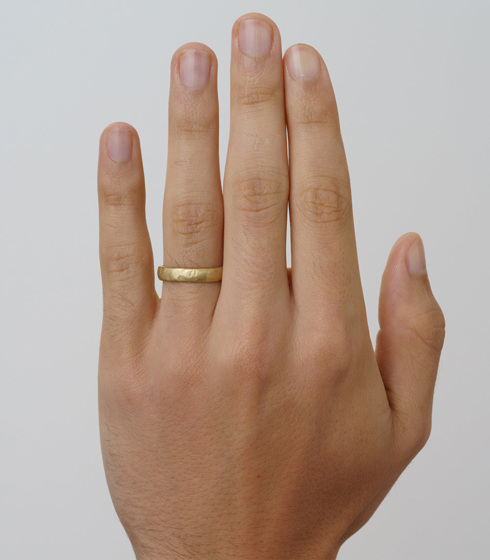 Raw Texture Wedding Band by M-R1-4.5 14K yellow gold raw texture wedding band on hand