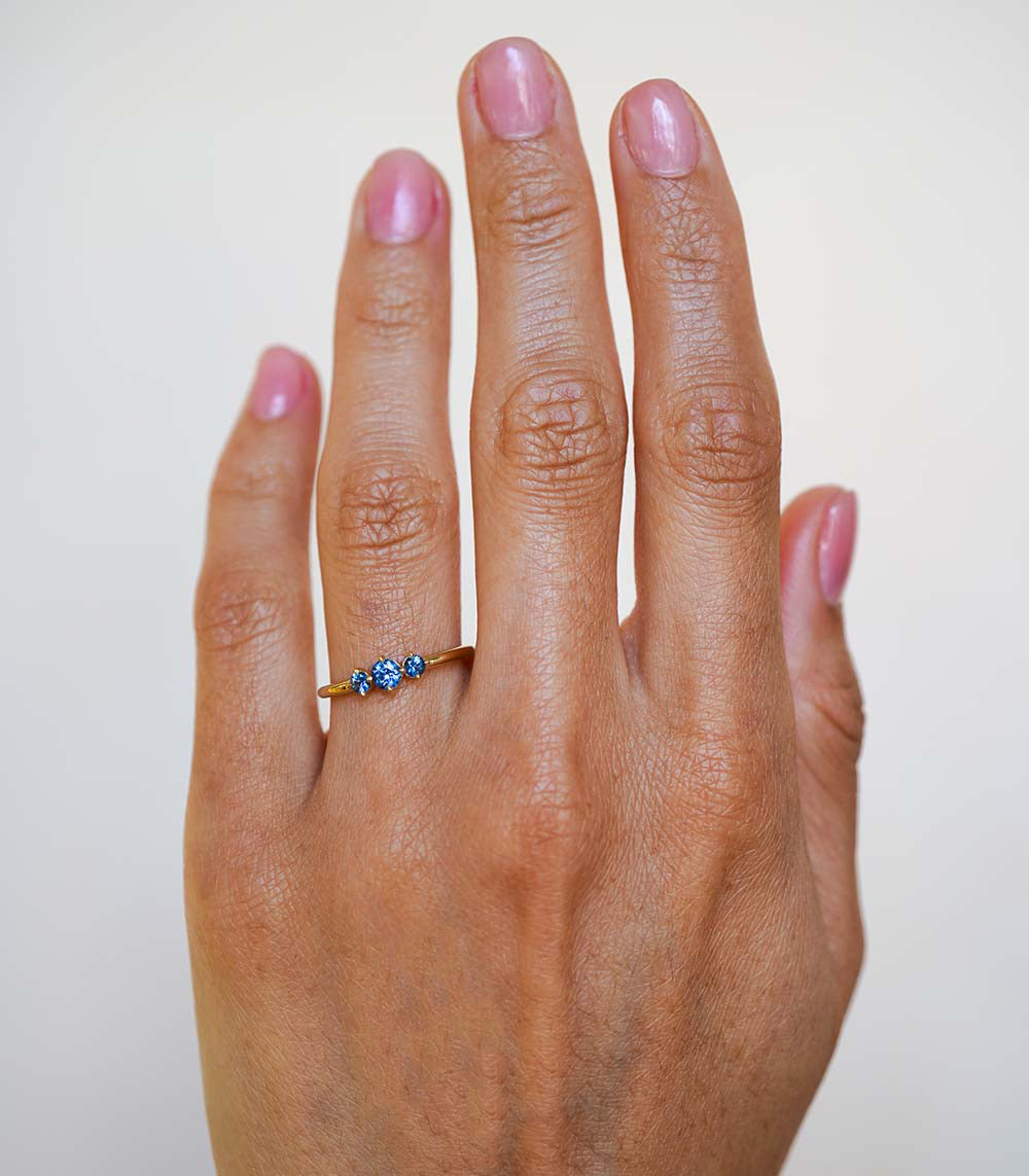Claudette Gemstone Stacking Band by SK-R68B-3-RB-CS-0.33 in gold with three blue stones on a slim band