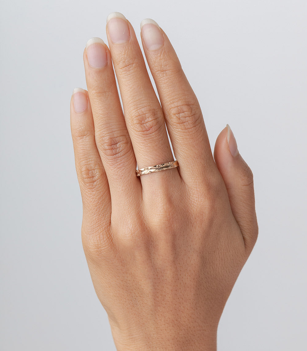 Orange Blossoms Stacking Band by VC-R141 gold stacking band with floral texture on finger