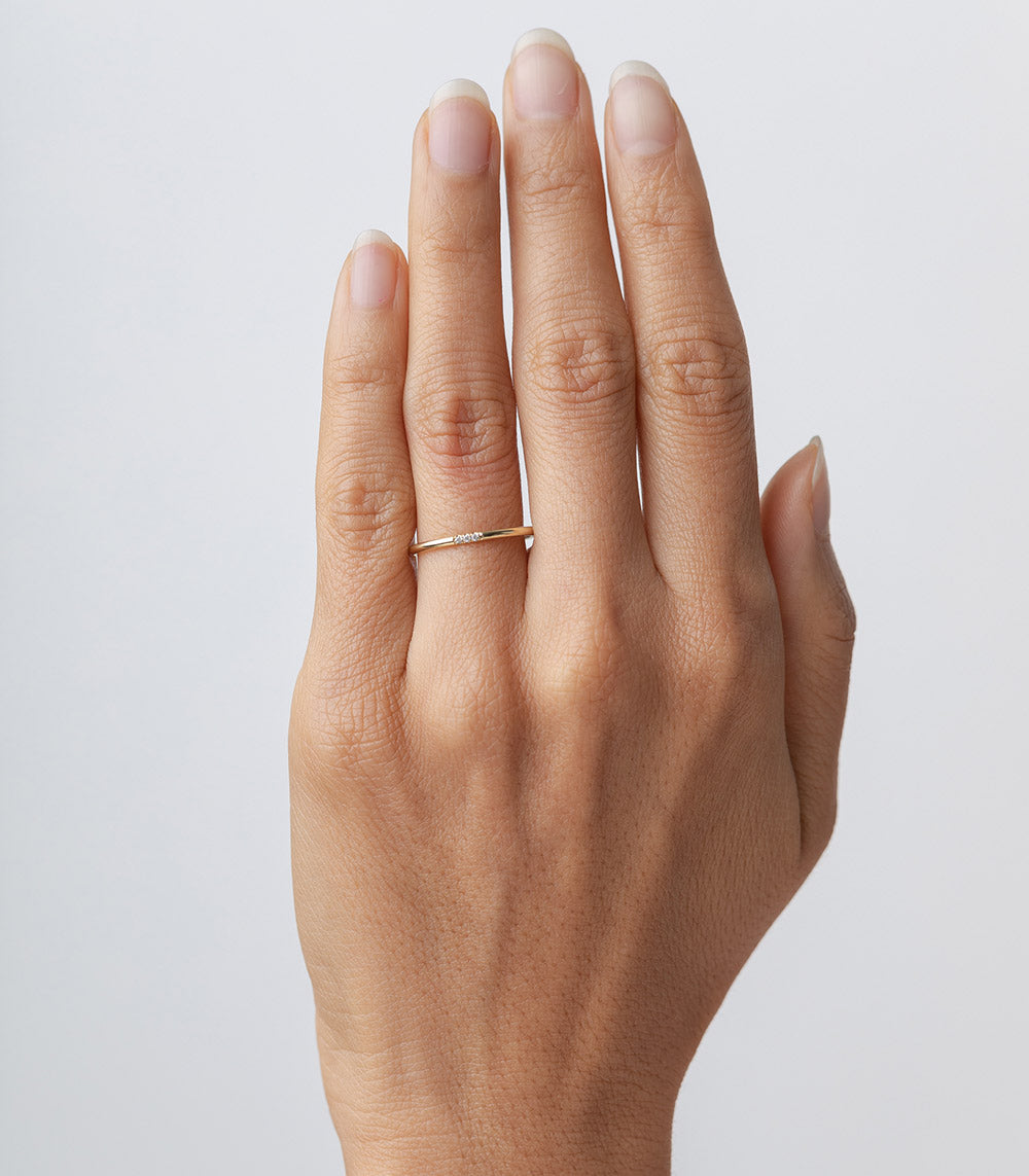 Classic Wire Band by A-R28, 14K yellow gold shiny ring on hand with slim profile.