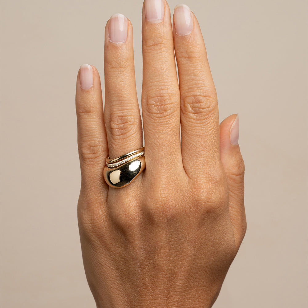 Mega Melt EGB-R17 14K yellow gold ring with shiny stacked curved band on finger closeup
