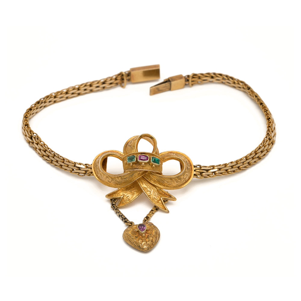 Spellbound Bow Bracelet VC-B11 gold chain bracelet with bow charm and purple heart stone detail.