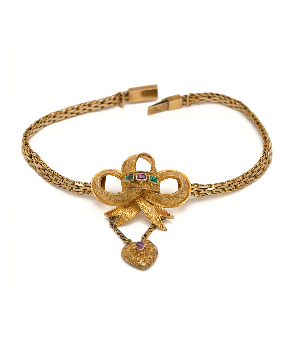 Spellbound Bow Bracelet VC-B11 gold chain bracelet with bow charm and purple heart stone detail.