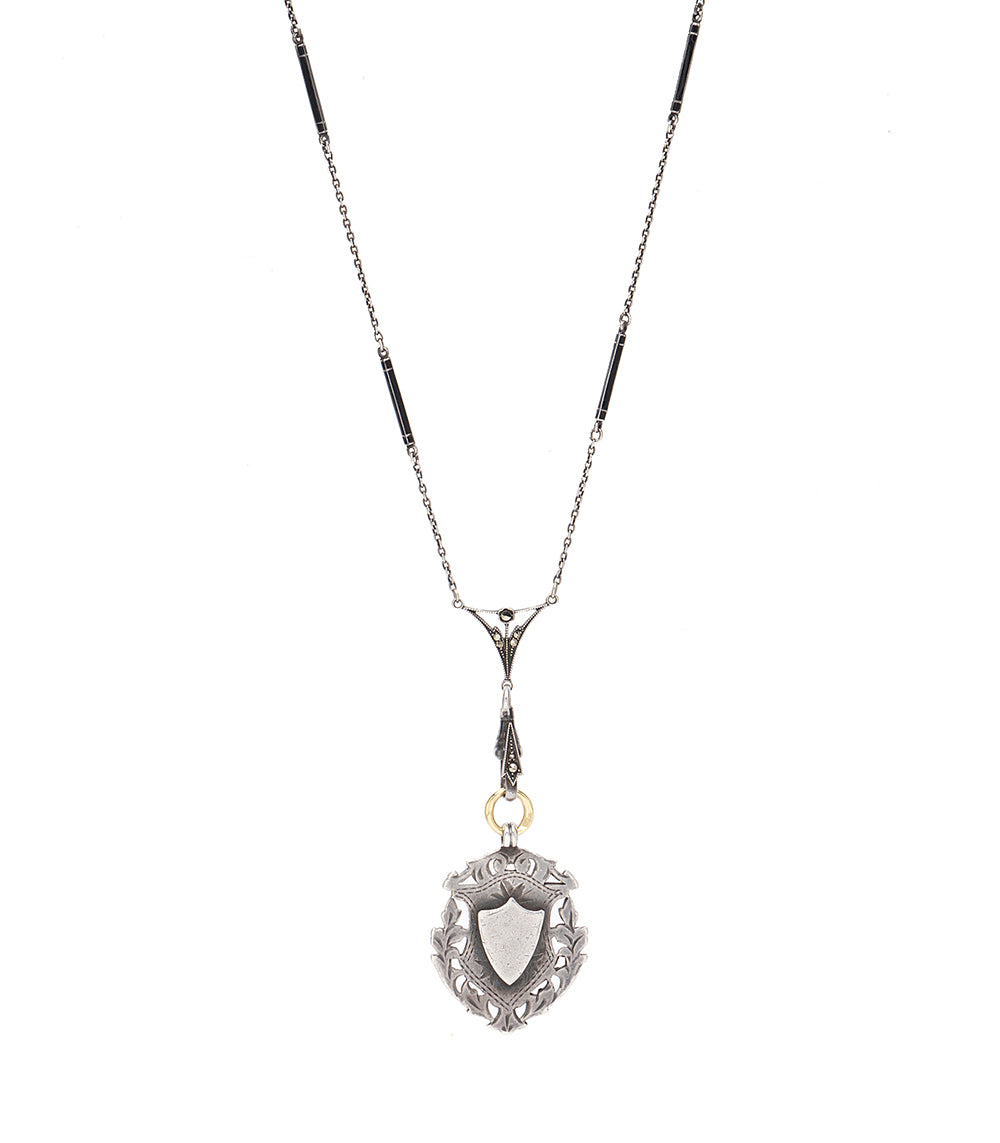 Midnight in Paris VC-C4 pendant necklace in silver with black accents and a shield crest charm.
