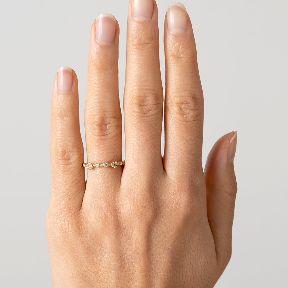 Twig Band ES-R26 14K yellow gold ring band with shiny finish and small round diamonds on hand