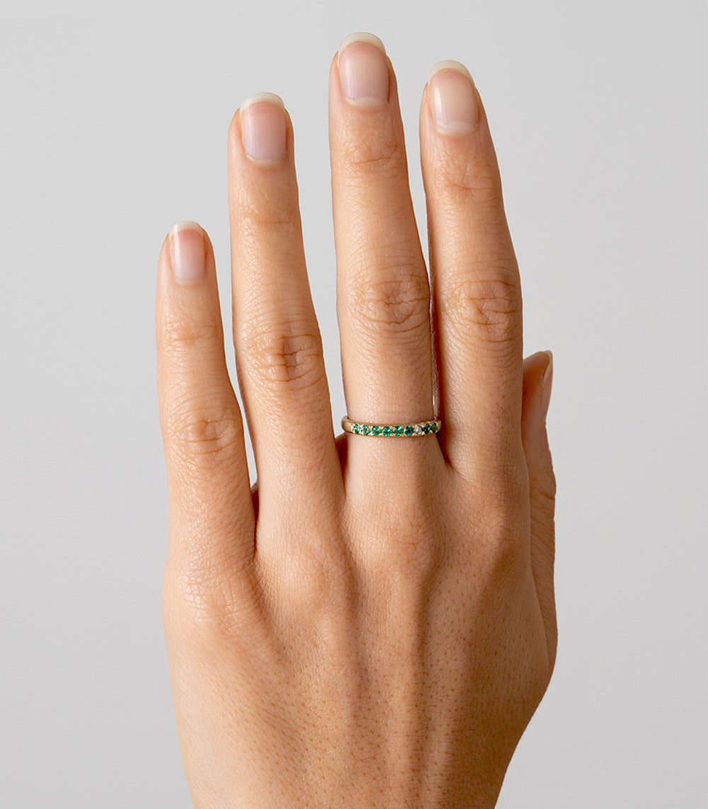Vintage Inspired Stacking Band LF-R1-ES 14K yellow gold with green stones, shiny band on hand
