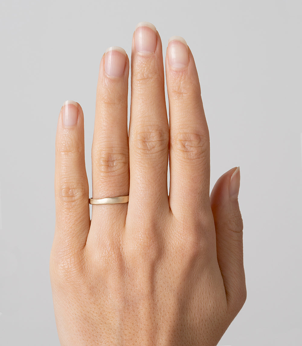 Torn Paper Band by P-R1, 14K rose gold band, shiny torn-paper edge detail on a hand