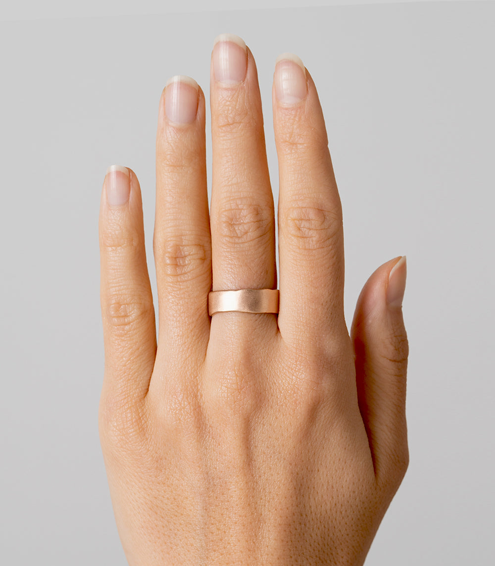 Torn Paper Band by P-R3-Engr in 14K rose gold shiny finish, shown on finger against light gray background