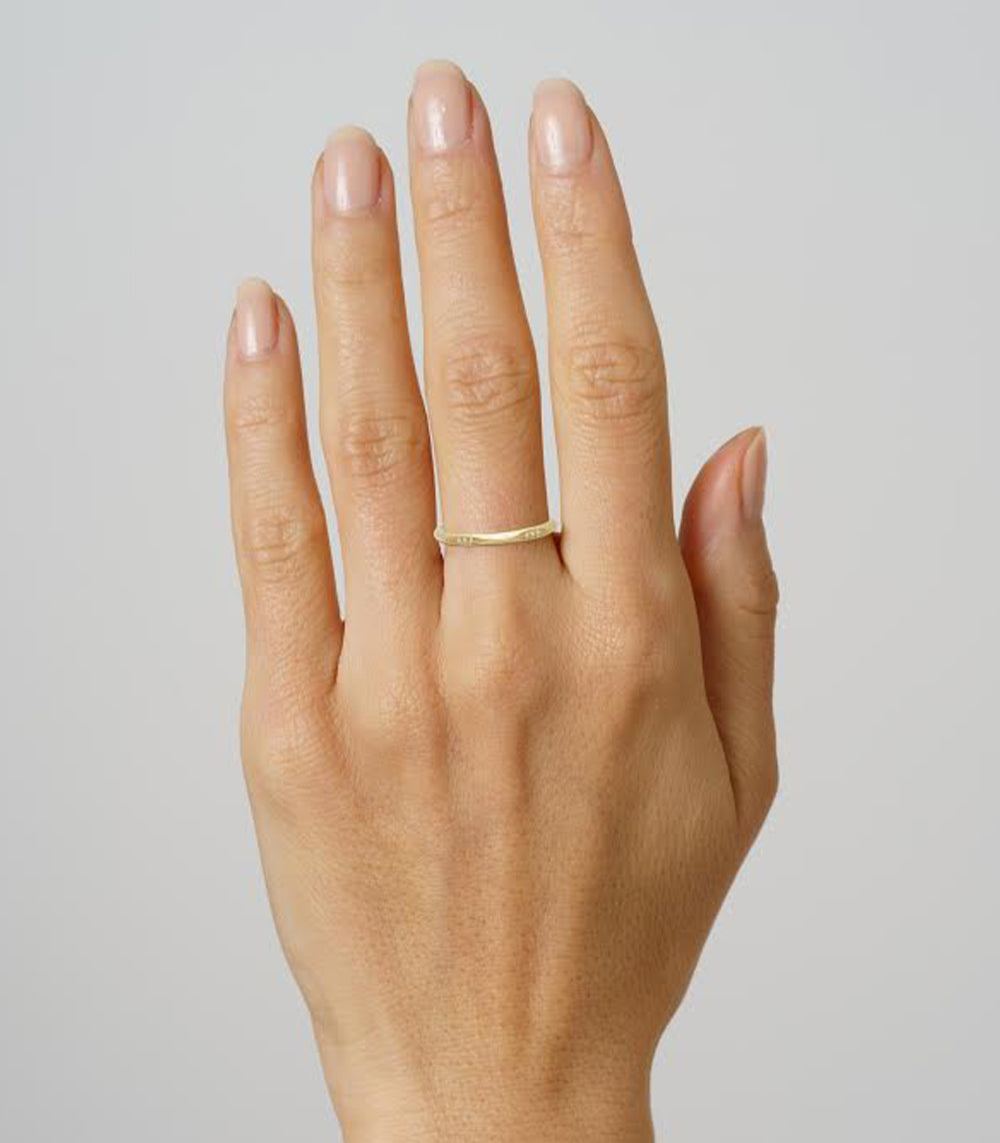 Evangeline SK-R92-B understated 14K yellow gold band ring on a hand, slim shiny-look profile