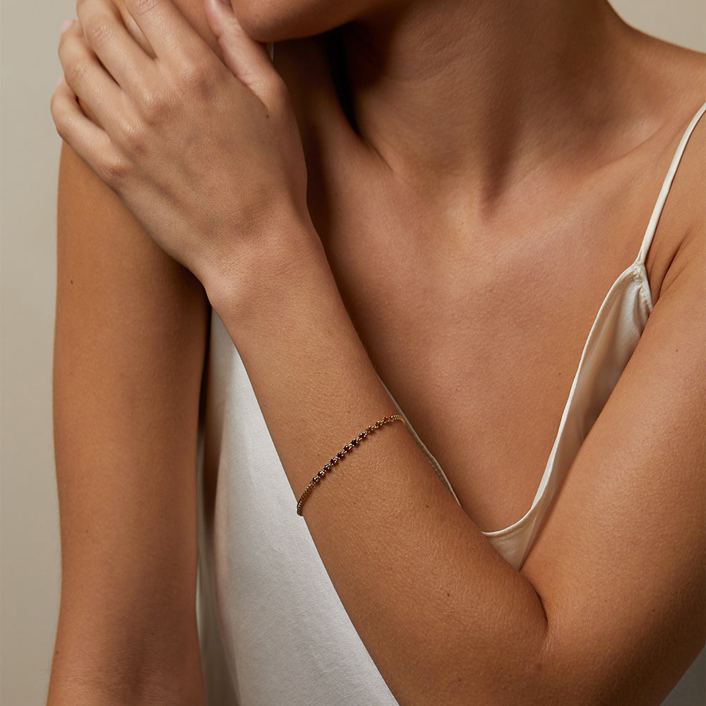 The Sunset SK-B6 gold bracelet with delicate beaded chain detail on wrist in soft light