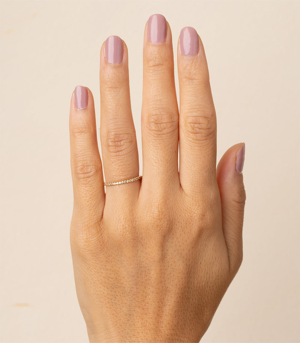 Classic Wire Band A-R29-CD understated 14K yellow gold shiny wire band on hand with pink nails