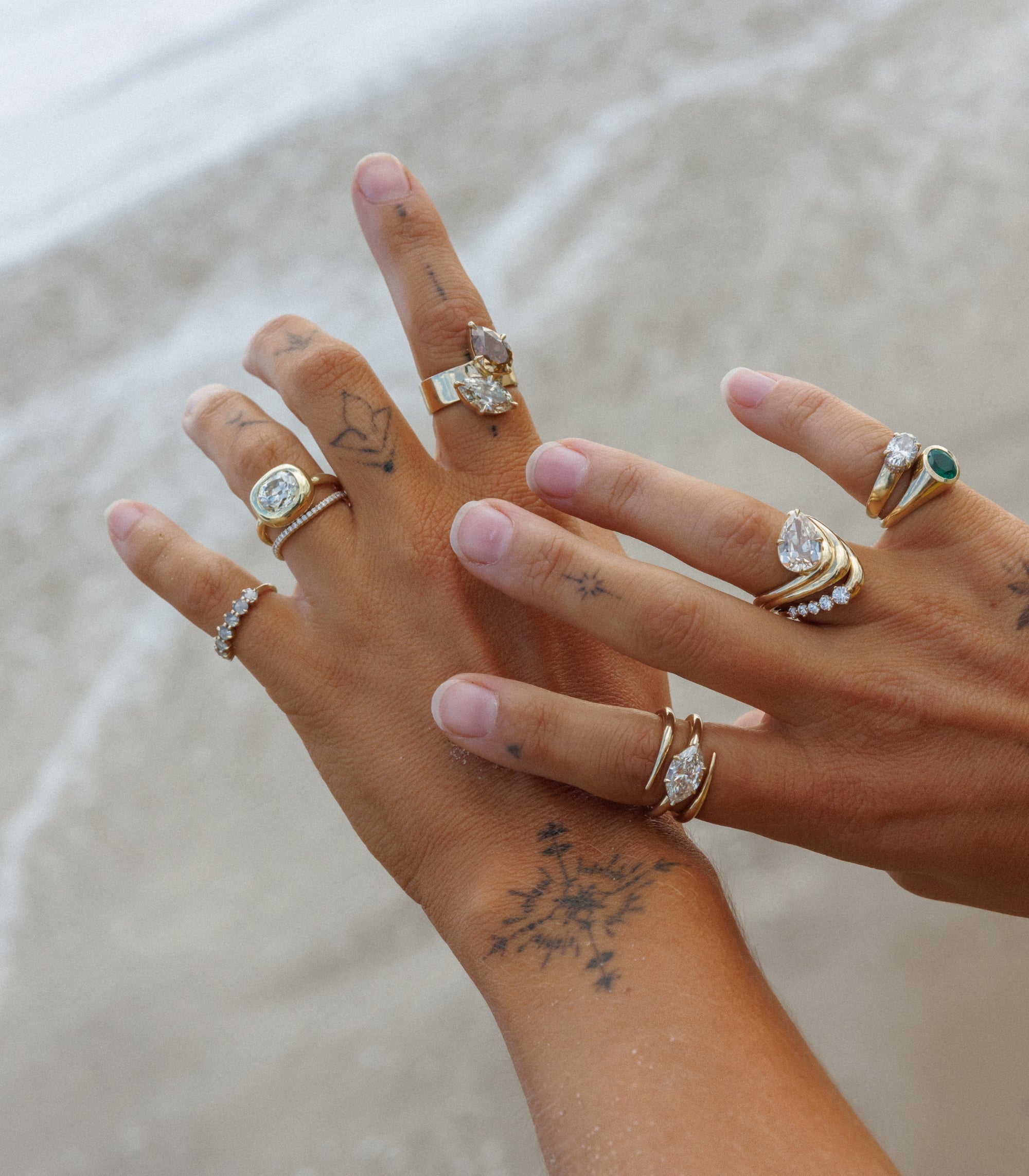Woman Holding Hands Over Ocean Showing Her One Of A Kind Unique Fine Jewelry Engagement Rings With Natural Champagne Diamonds Conflict Free Stones