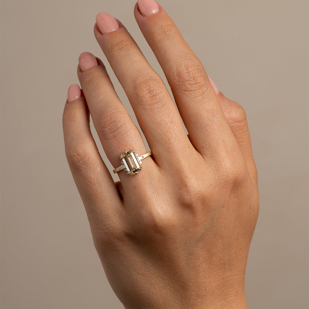 Melina by SK-R72-CD-EC-2.53 gold engagement ring with three rectangular stones on finger