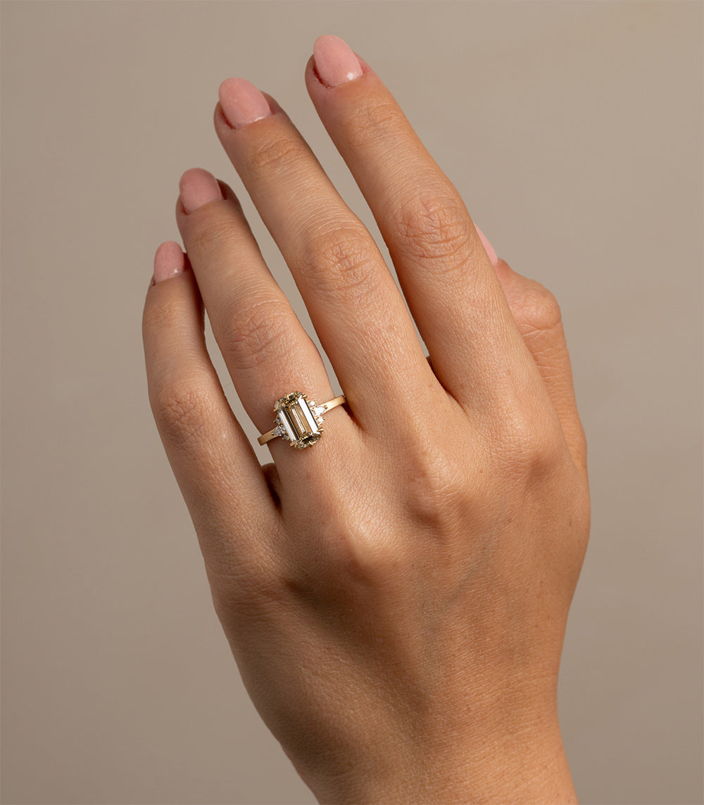 Melina by SK-R72-CD-EC-2.53 gold engagement ring with three rectangular stones on finger